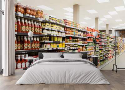 Stocked shelves in grocery store aisle Wall mural