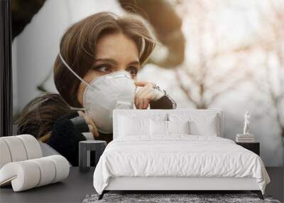 Woman outdoors in city with a face mask against infection and viruses such as flu, corona virus, sars or swine influenca Wall mural