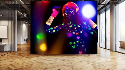 Female dancer in glow UV costume Wall mural