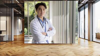 Portrait of young asian male doctor or professional in ground uniform Wall mural