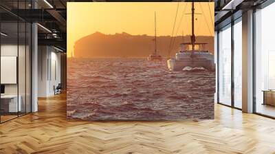 Greece, catamaran boats in the famous sunset of greek island Santorini Wall mural