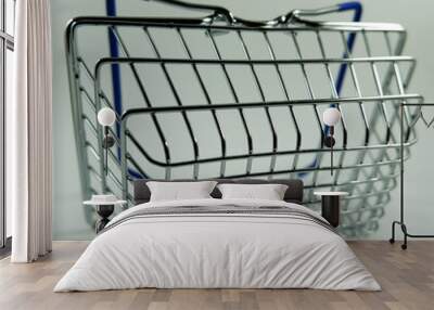 isolated shopping basket lying on its side on white background Wall mural