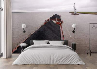 Cargo ship with coal at Kolyma river Russia outback Wall mural