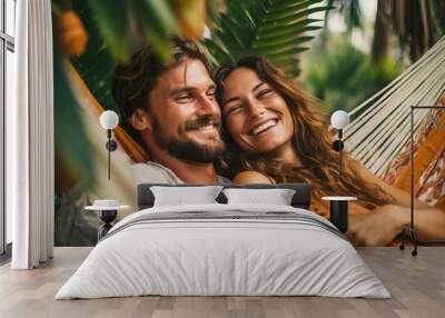 A fictional person.  Smiling Couple Relaxing in Hammocks Among Palm Trees Wall mural