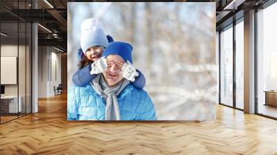 father and daughter playing in the snow in winter Wall mural