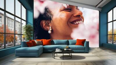 Happy woman, smiling, showing her white teeth among the pink spring flowers on a sunny morning day. Perfect ted girl, beautiful, with soft makeup among the softness of the flowers. Wall mural