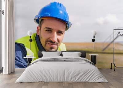 Male engineer working in field Wall mural