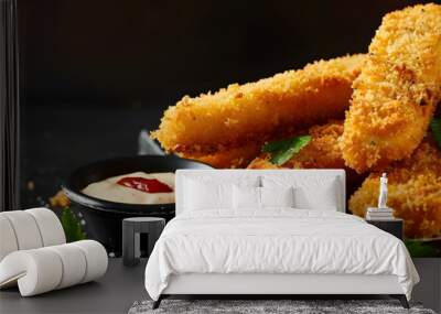 A close up view of fresh fish fingers coated in breadcrumbs served with sauce and a slice of lemon on a grey table providing ample copy space for the image Wall mural