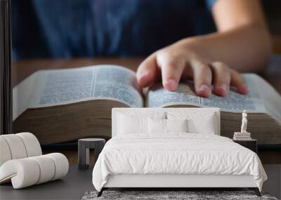 A teenage hand resting on the Bible's pages Wall mural