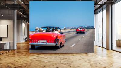 Havana Cuba. Old American cars runing along the malecon in la Habana. Wall mural