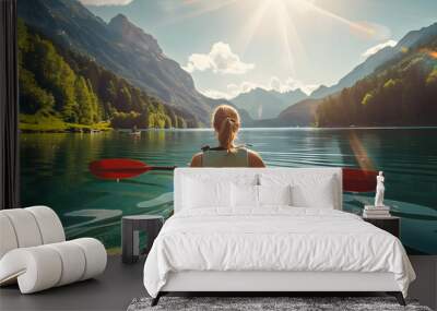 back view of woman kayaking in crystal lake near alps mountains, Wall mural