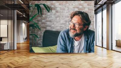 Cheerful mature man in living room Wall mural