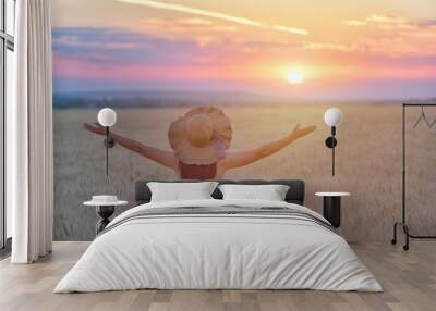 Woman feeling free, happy and loved in a beautiful natural setting at sunet Wall mural