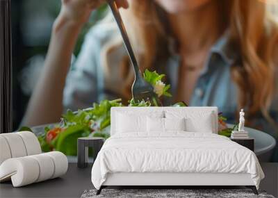 Close-up of woman eating healthy food salad Wall mural