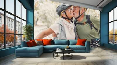 Couple of cute and sweet seniors in love enjoying together nature outdoors having fun with bikes. Old man kissing his wife smiling and feeling good.. Wall mural