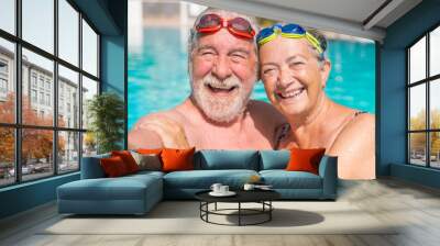 Couple of two happy seniors having fun and enjoying together in the swimming pool taking a selfie picture smiling and looking at the camera. Happy people enjoying summer outdoor in the water. Wall mural