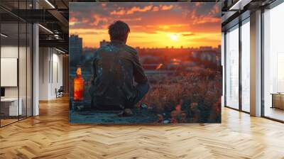 Depressed man drinking alcohol outdoors in the evening Wall mural