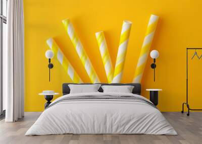 Drinking straw with stripes on yellow background Wall mural