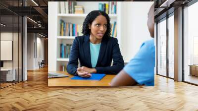 African american businesswoman talking to lazy employee Wall mural