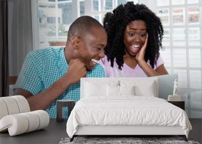 African american couple shopping presents and gifts online with laptop Wall mural