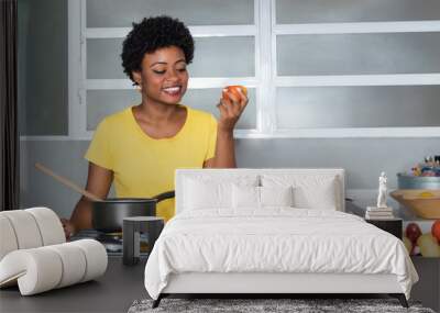 African american woman cooking with tomato Wall mural