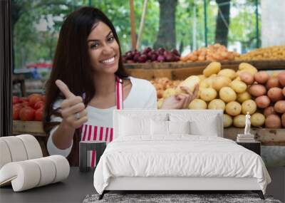 Latin american saleswoman at farmers market with potato and vegetables Wall mural