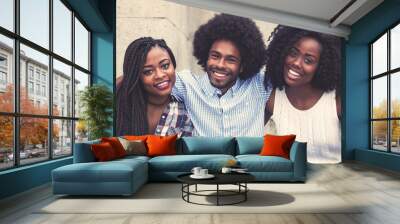 Laughing african american hipster man with two beautiful woman Wall mural