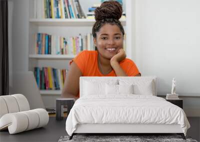 Laughing black female student learning for graduation Wall mural