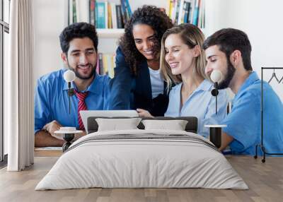 Multi ethnic group of software engineers and programmers at computer Wall mural