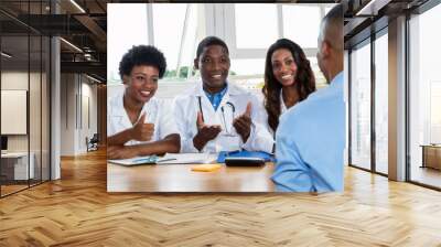 Team of doctors gratulating patient to healthy lifestyle Wall mural