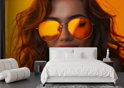 Exultant woman with opaque orange glasses. Wall mural