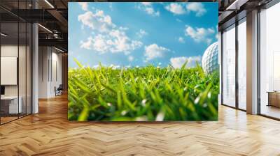 Golf Ball on Green Grass With Blue Sky and Clouds Wall mural