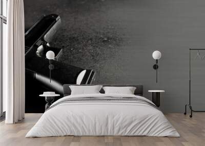 Gun on black table, criminal concept Wall mural