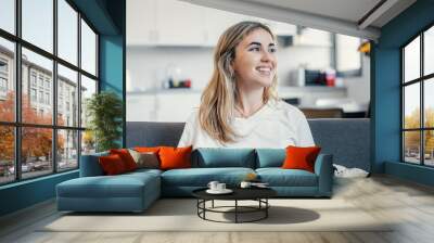 Head shot close up dreamy young smiling beautiful woman looking away, visualizing future indoors of recollecting good memories. Happy healthy millennial girl enjoying free weekend time at home.. Wall mural