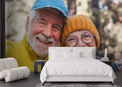 Head shot portrait close up of cute couple of old seniors taking a selfie together in the mountain forest looking at the camera smiling having fun enjoying. Two mature people hiking. Wall mural