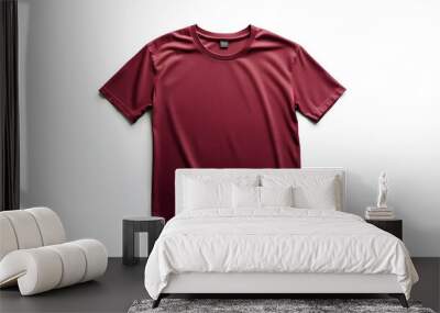 Isolated shot of a blank maroon t-shirt with a crew neck and short sleeves, folded neatly on a crisp white background, ready for customization. Wall mural