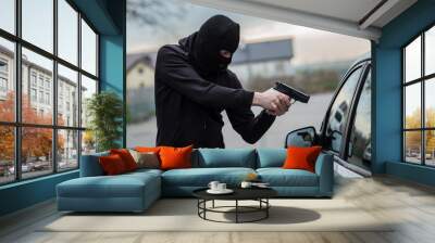 car thief pointing a gun at the driver Wall mural