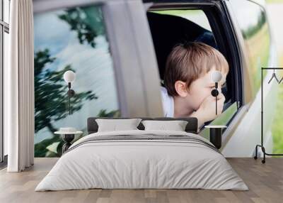 Child suffers from motion sickness in car Wall mural