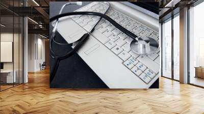 Laptop and a stethoscope on the desk.  Concept of computer diagnosis Wall mural