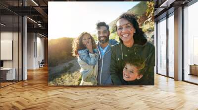 Children are one of the biggest influences of happiness. Cropped shot of a family of four spending the day outdoors. Wall mural