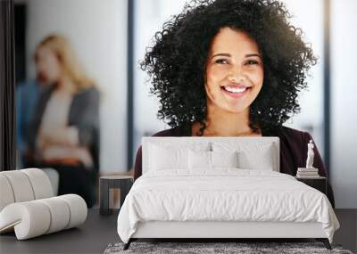 Closeup portrait of a happy, successful and confident business woman standing in a office. Beautiful African American female smiling, with her colleagues in the blurred copyspace background. Wall mural