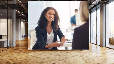 Interview with a happy, excited and confident human resources manager talking to a shortlist candidate for a job. Young business woman meeting with a colleague or coworker in her office at work Wall mural