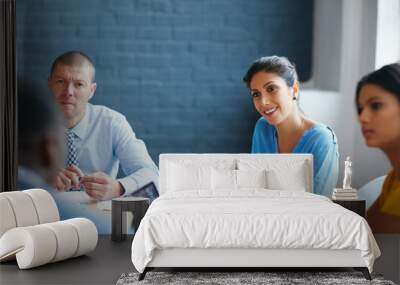 Listening with intent. Cropped shot of a group of businesspeople in the boardroom. Wall mural