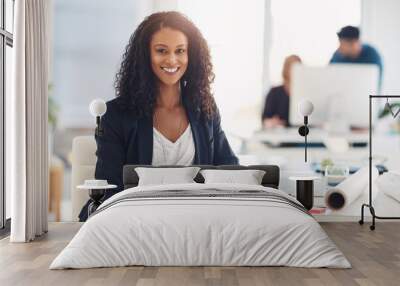 Passion put this smile on my face. Portrait of a young woman working at her desk in a modern office. Wall mural