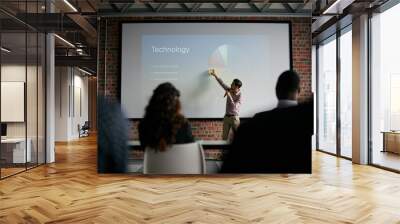 Presenting key notes to his colleagues. Shot of a businessman giving a presentation to his colleagues. Wall mural