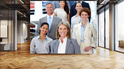 She leads the way. Portrait of a diverse group of businesspeople in the office. Wall mural