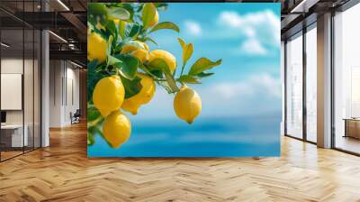 Lemon fruits growing on tree with blurry ocean and blue sky in background Wall mural