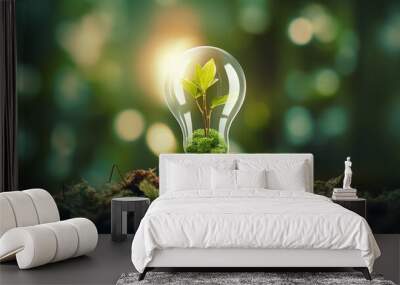 light bulb with green plant inside on green grass, nature and environment concept Wall mural