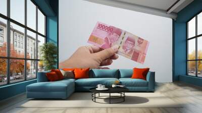 Hands and Rupiah isolated on a white background Wall mural