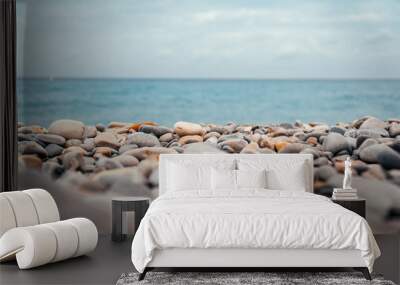 Pebble and stone rock beach with blue ocean 2 Wall mural